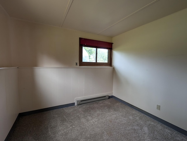 unfurnished room featuring a baseboard radiator and carpet floors