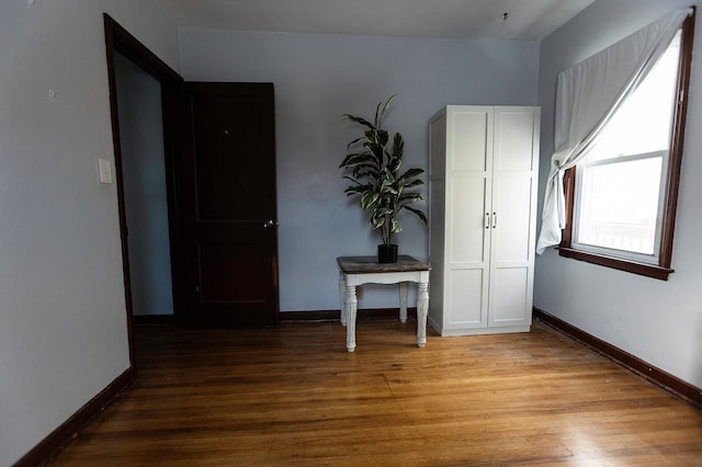 empty room featuring light wood-type flooring and baseboards