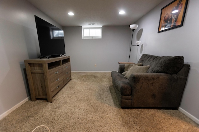 living area featuring recessed lighting, baseboards, and light colored carpet