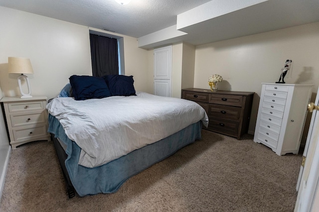 bedroom featuring a textured ceiling, carpet floors, and visible vents