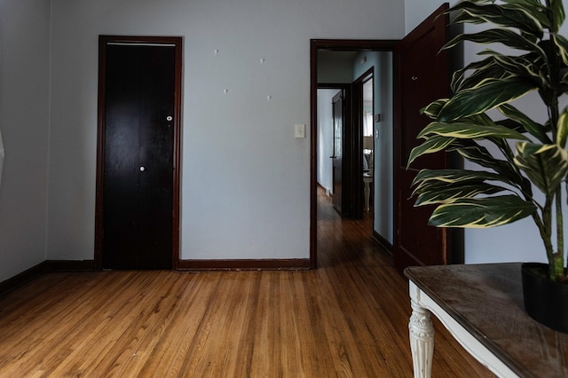 empty room featuring baseboards and wood finished floors