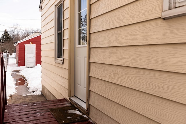 view of snow covered exterior with fence