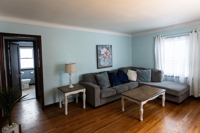 living room with baseboards and wood finished floors