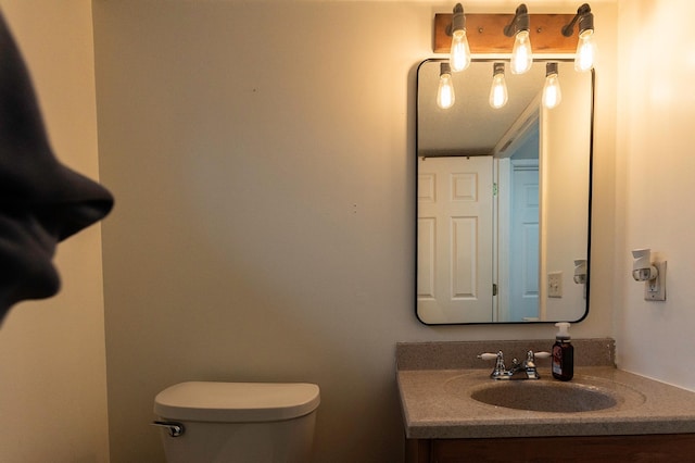 bathroom with toilet and vanity