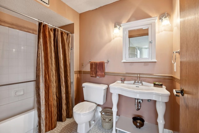 bathroom with toilet, tile patterned floors, and shower / bathtub combination with curtain