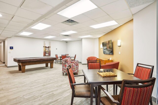 rec room with billiards, light hardwood / wood-style flooring, and a drop ceiling