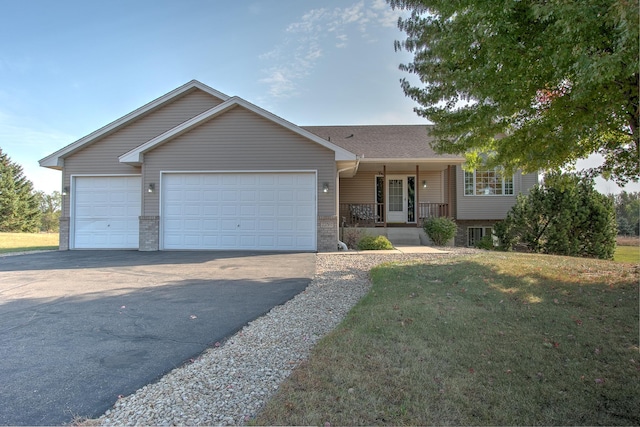 view of front of property featuring a front lawn, a porch, and a garage