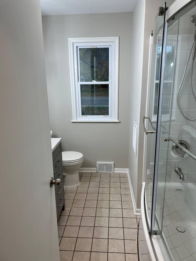 full bathroom with vanity, baseboards, visible vents, tile patterned floors, and a stall shower