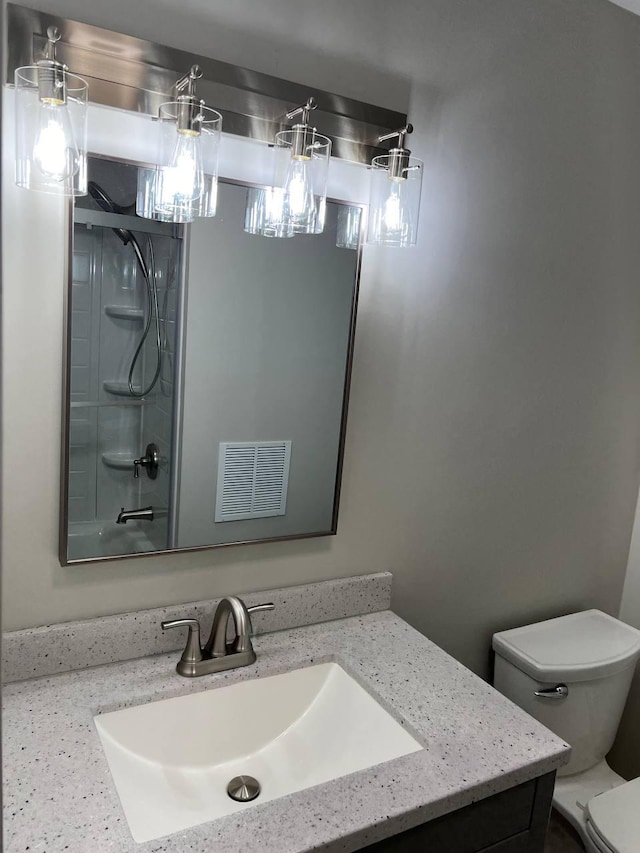 full bath featuring visible vents, vanity, and toilet