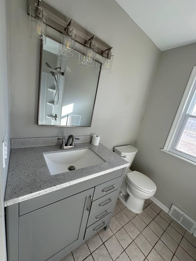 full bath featuring visible vents, toilet, vanity, tile patterned flooring, and walk in shower