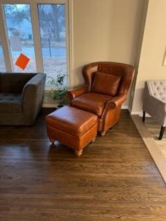 living area with dark wood finished floors and baseboards