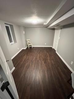 finished basement featuring wood finished floors and baseboards