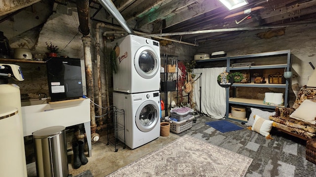 laundry room with stacked washer and dryer and laundry area