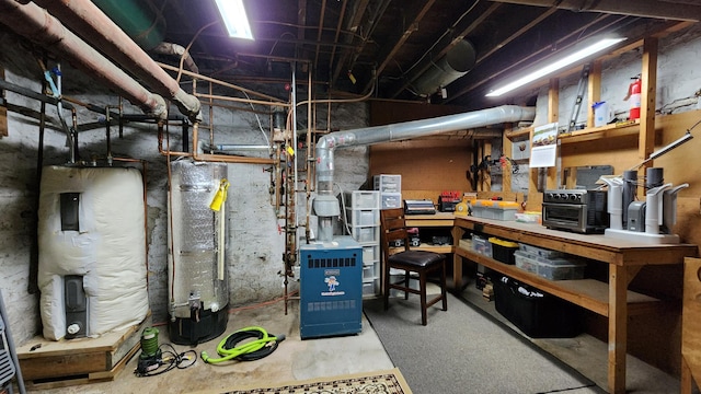 utility room featuring water heater and a heating unit