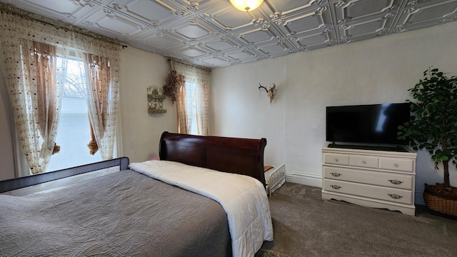 carpeted bedroom with an ornate ceiling