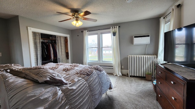 bedroom featuring an AC wall unit, a closet, light carpet, a textured ceiling, and radiator