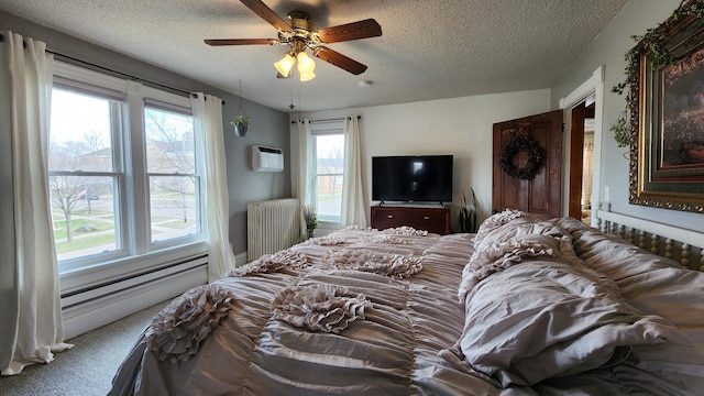 bedroom with a textured ceiling, radiator heating unit, multiple windows, and an AC wall unit