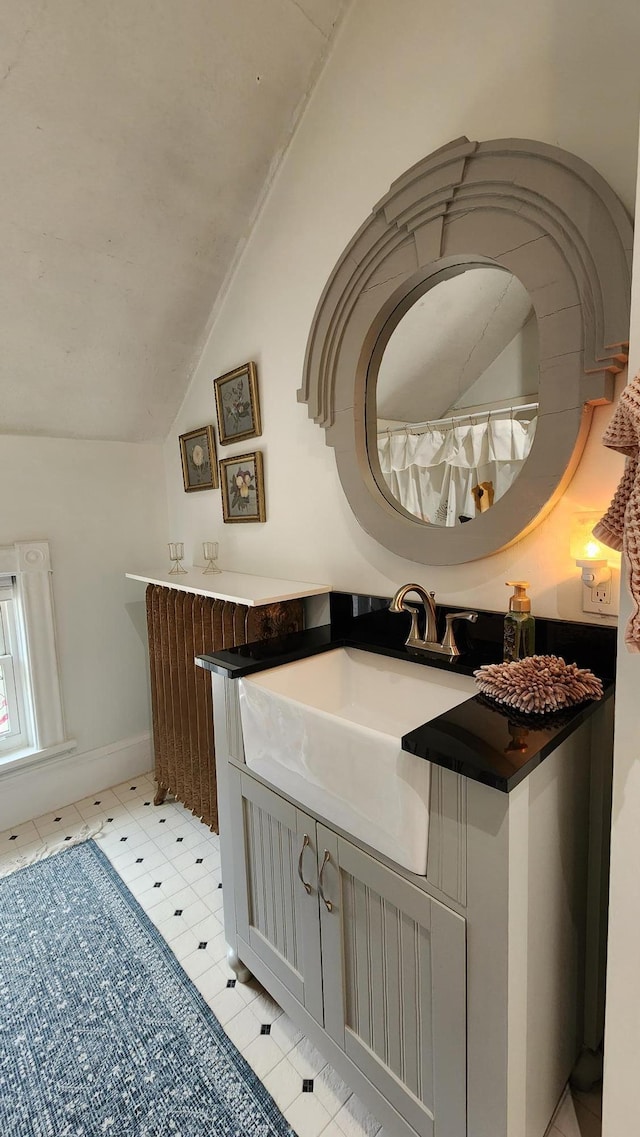 bathroom with vanity and vaulted ceiling