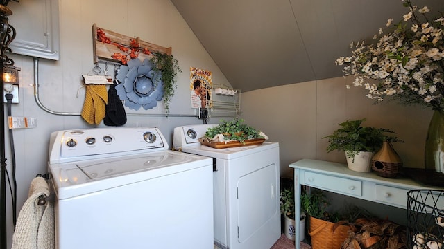 washroom featuring laundry area, electric panel, and washer and clothes dryer