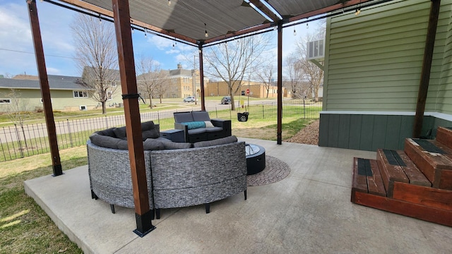 view of patio / terrace featuring an outdoor hangout area, fence, and a residential view