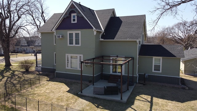 rear view of property with a patio, fence, roof with shingles, and a lawn