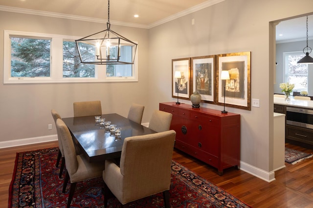 dining area featuring dark hardwood / wood-style flooring and ornamental molding