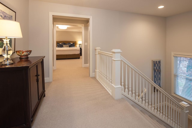 hallway with light colored carpet