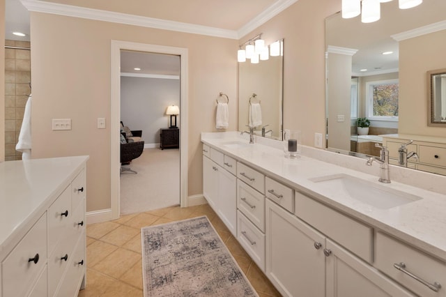 bathroom with crown molding, vanity, and tile patterned flooring