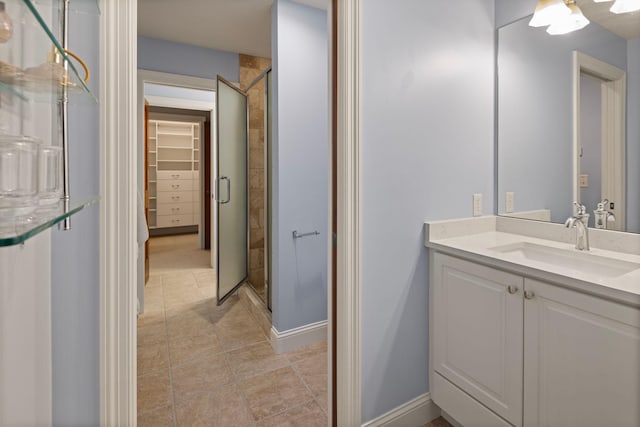 bathroom featuring vanity, tile patterned floors, and walk in shower