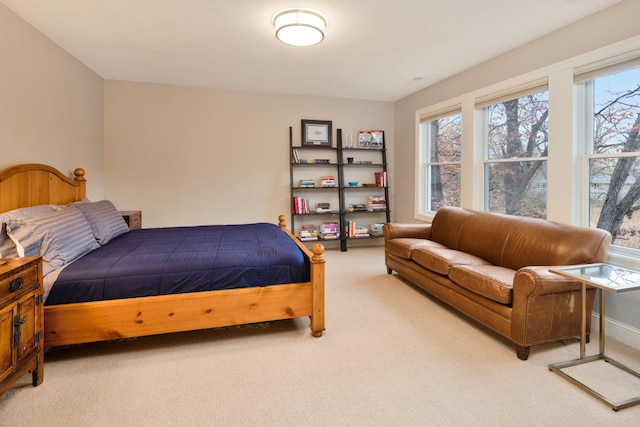 bedroom with multiple windows and carpet flooring