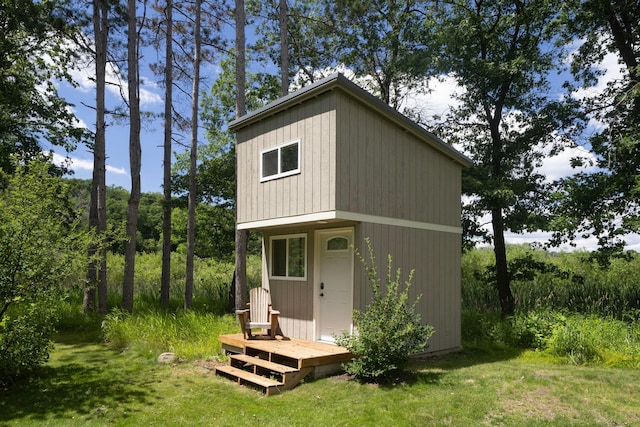 view of outdoor structure featuring a lawn