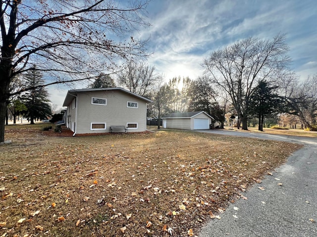 view of side of home featuring a garage and an outdoor structure