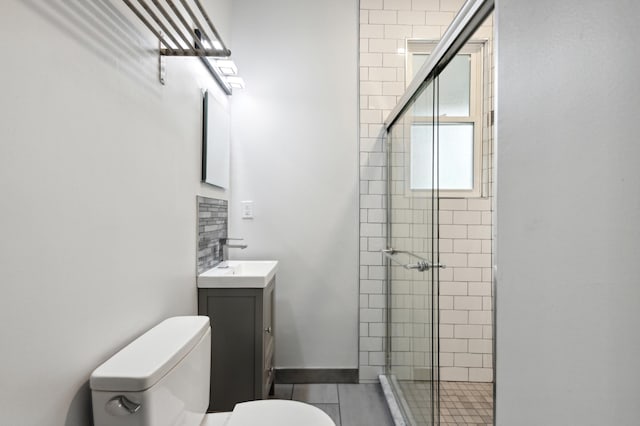 bathroom featuring walk in shower, vanity, toilet, and tile patterned floors