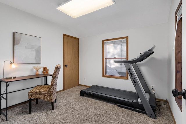 exercise area with lofted ceiling, carpet, and baseboards