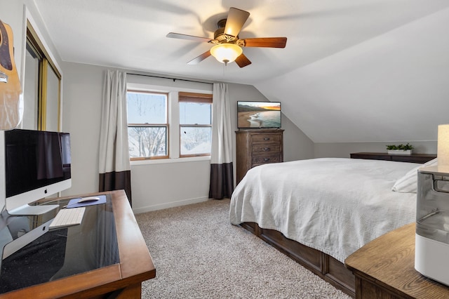 bedroom featuring lofted ceiling, ceiling fan, baseboards, a closet, and carpet