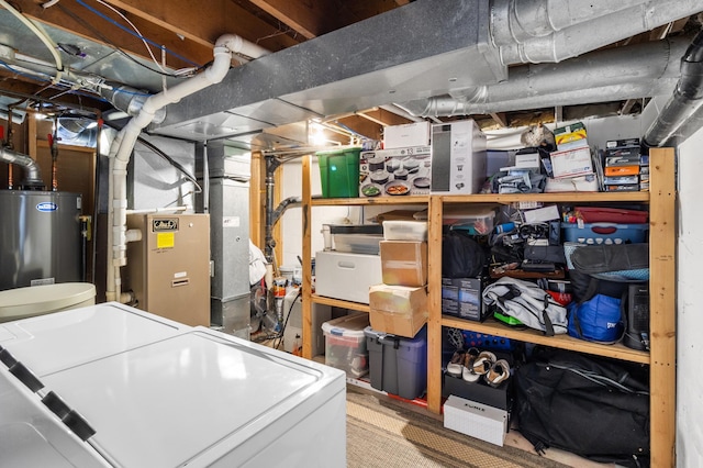 storage area featuring water heater and independent washer and dryer