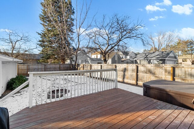 deck with a fenced backyard, a covered hot tub, and a residential view