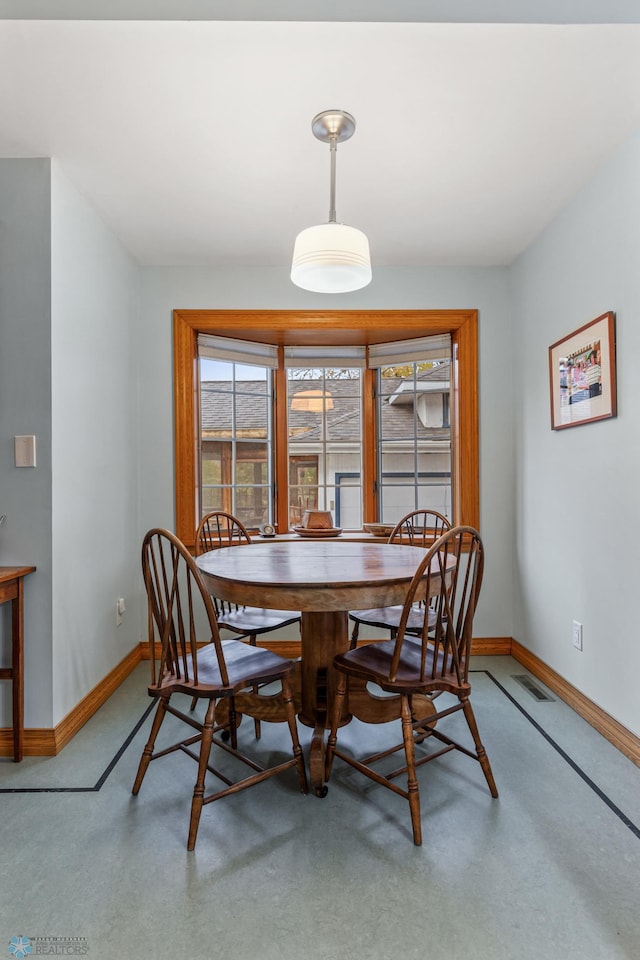 dining room featuring concrete flooring