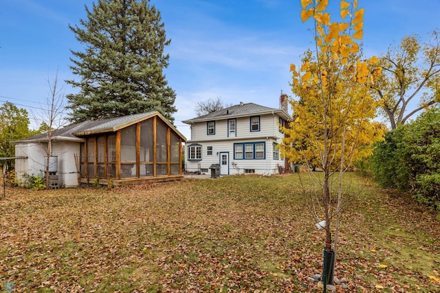 rear view of property featuring a sunroom and a patio