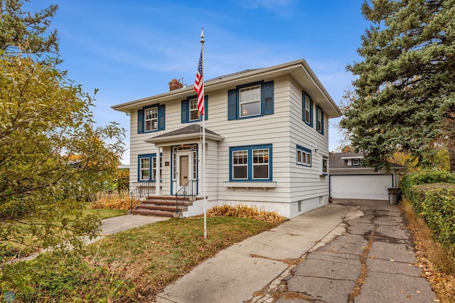 view of front of home featuring a garage and an outdoor structure