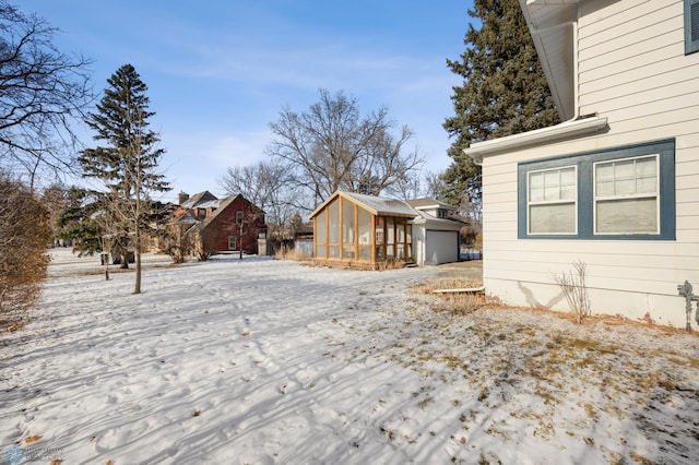 view of snow covered exterior featuring an outdoor structure