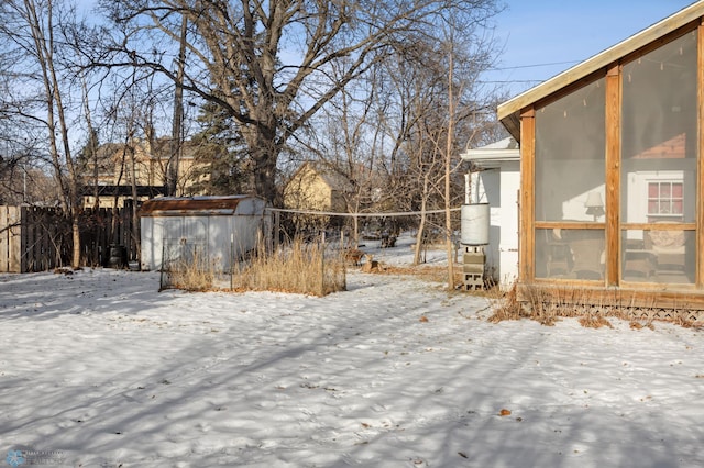 snowy yard with a storage unit