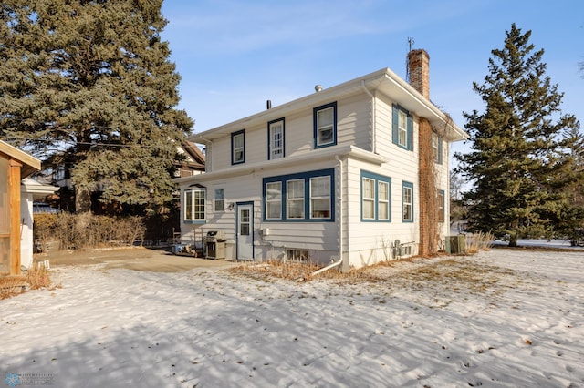 rear view of house featuring cooling unit