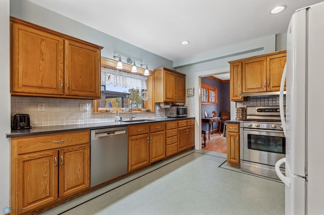 kitchen featuring backsplash, sink, and appliances with stainless steel finishes