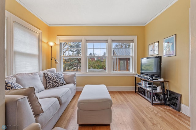 living room with light hardwood / wood-style flooring and ornamental molding