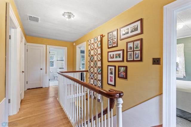 corridor with light hardwood / wood-style flooring