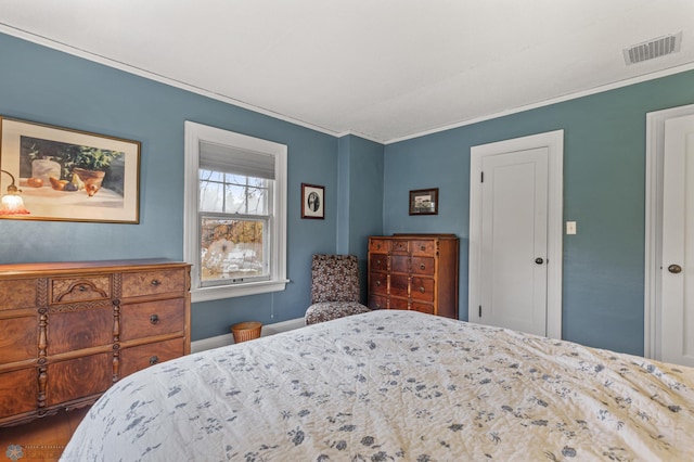 bedroom with crown molding and hardwood / wood-style floors