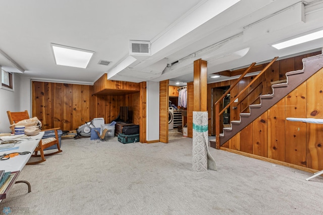 basement with carpet and wood walls