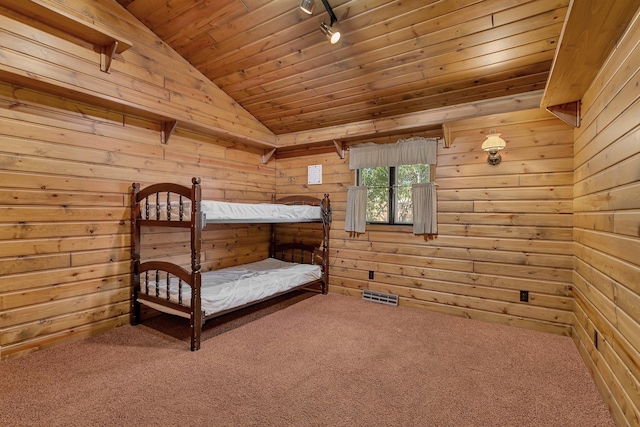 unfurnished bedroom featuring visible vents, carpet floors, vaulted ceiling, rail lighting, and wooden ceiling