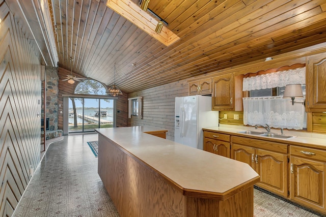 kitchen featuring a sink, a center island, white fridge with ice dispenser, light countertops, and wood ceiling